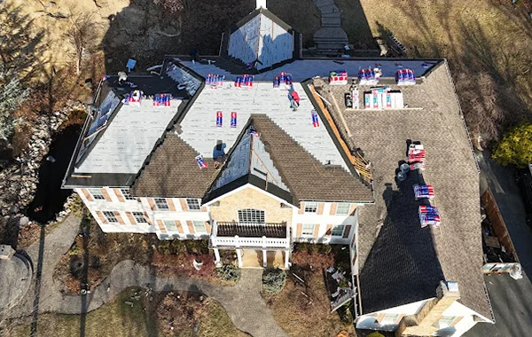Large, high-end home undergoing a roof replacement